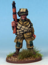 Paratrooper of the 82nd Airborne Division. The cross belts are ammunition bandoliers and he carries a smoke grenade with a white stripe in his webbing.  