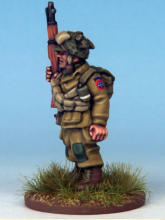 Paratrooper of the 82nd Airborne Division. The cross belts are ammunition bandoliers and he carries a smoke grenade with a white stripe in his webbing.  