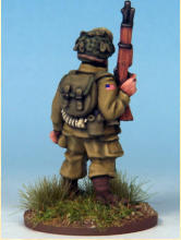 Paratrooper of the 82nd Airborne Division. The cross belts are ammunition bandoliers and he carries a smoke grenade with a white stripe in his webbing.  