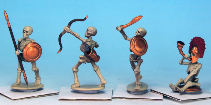 I then painted in all the rest of the skeletons that aren’t bone! Using Army Painter Warpaints, the bow, arrow shafts, spear-shaft and back of shields in Werewolf Fur – all the metalwork in Weapon Bronze – crest in Dragon Red – 