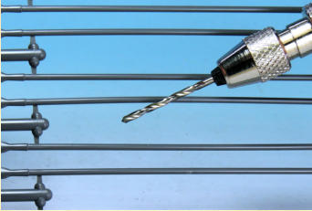 The spears have a diameter of 1.3mm; my nearest drill bit is 1.4mm, close enough to allow some play.