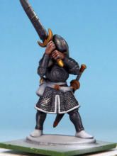 The flesh is painted with Crusader Skin. I applied a coat of Crusader Skin to the sword hilts, buckles, and sections of the greaves, muting the Glittering Loot and sharpening the details.