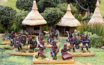 Some of James Morris' Azande Army for Death in the Dark Continent, stood in front of his superb scratch built Azande Village.